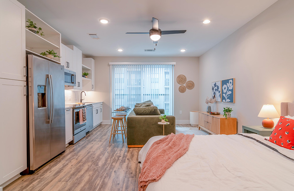 Bedroom with large bed, ensuite. queen bed and nightstands.