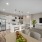 kitchen with white cabinets open to dining and living area
