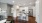 kitchen with white cabinets and kitchen island with stools