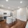 kitchen with white cabinets and kitchen island with stools