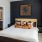 Model bedroom at our apartments in Atlanta, featuring carpeted flooring and a view of the bathroom.