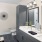 Model bathroom at our apartments in Atlanta, featuring tiled floor panels and white countertops and grey cabinetry.