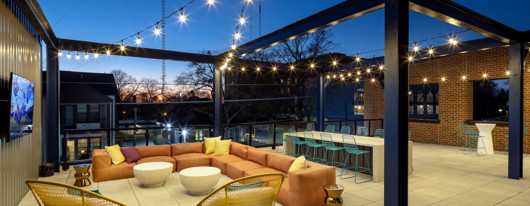 rooftop with seating, televisions and bartop area