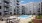 Outdoor view of pool deck with picnic tables