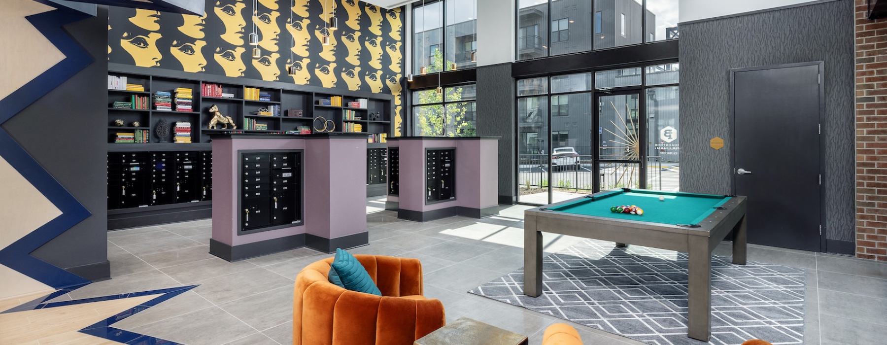 Entertainment room and lounge at our apartments in Atlanta, featuring cushioned chairs and a billiards table.